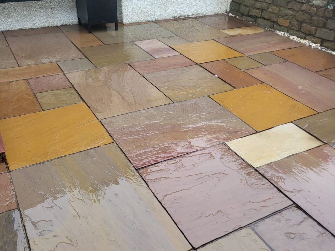 Patio after cleaning, sandstone slabs restored